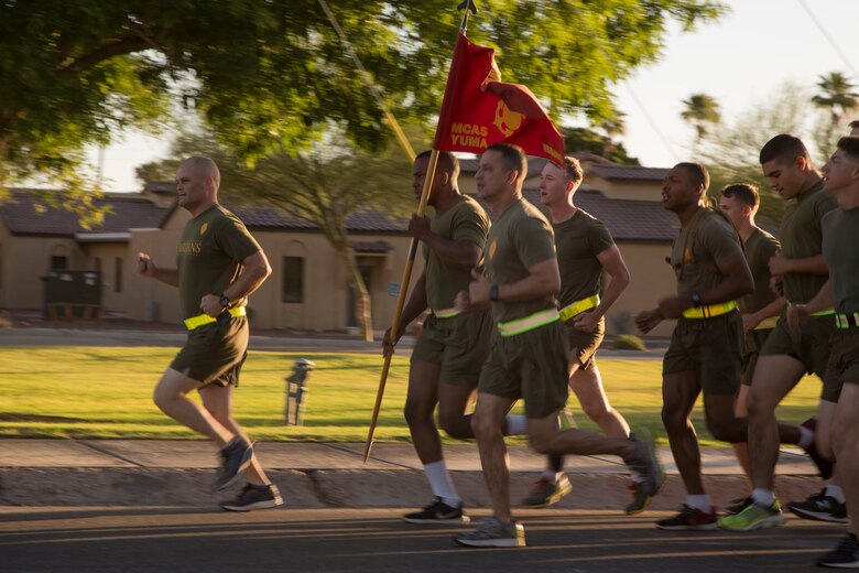 U.S. Marine Corps Lt. Col. James S. Tanis, commanding officer of Headquarters and Headquarters Squadron (H&HS), Marine Corps Air Station (MCAS) Yuma, Ariz., leads a motivational run on MCAS Yuma, Ariz., May 25, 2018. H&HS conducted the motivational run to kick off the Memorial Day 96 hour liberty period, and to say farewell to Lt. Col. Tanis who served as the commanding officer of H&HS  for the past two years. (U.S. Marine Corps photo by Sgt. Allison Lotz)