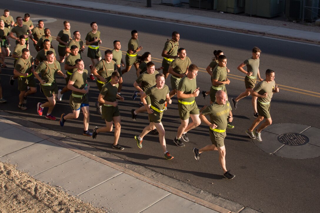 U.S. Marines stationed with Headquarters and Headquarters Squadron (H&HS), Marine Corps Air Station (MCAS) Yuma, Ariz., conduct a motivational run on MCAS Yuma, Ariz., May 25, 2018. H&HS conducted the motivational run to kick off the Memorial Day 96 hour liberty period, and to say farewell to Lt. Col. James S. Tanis. Lt. Col. Tanis served as the commanding officer of H&HS  for the past two years. (U.S. Marine Corps photo by Sgt. Allison Lotz)