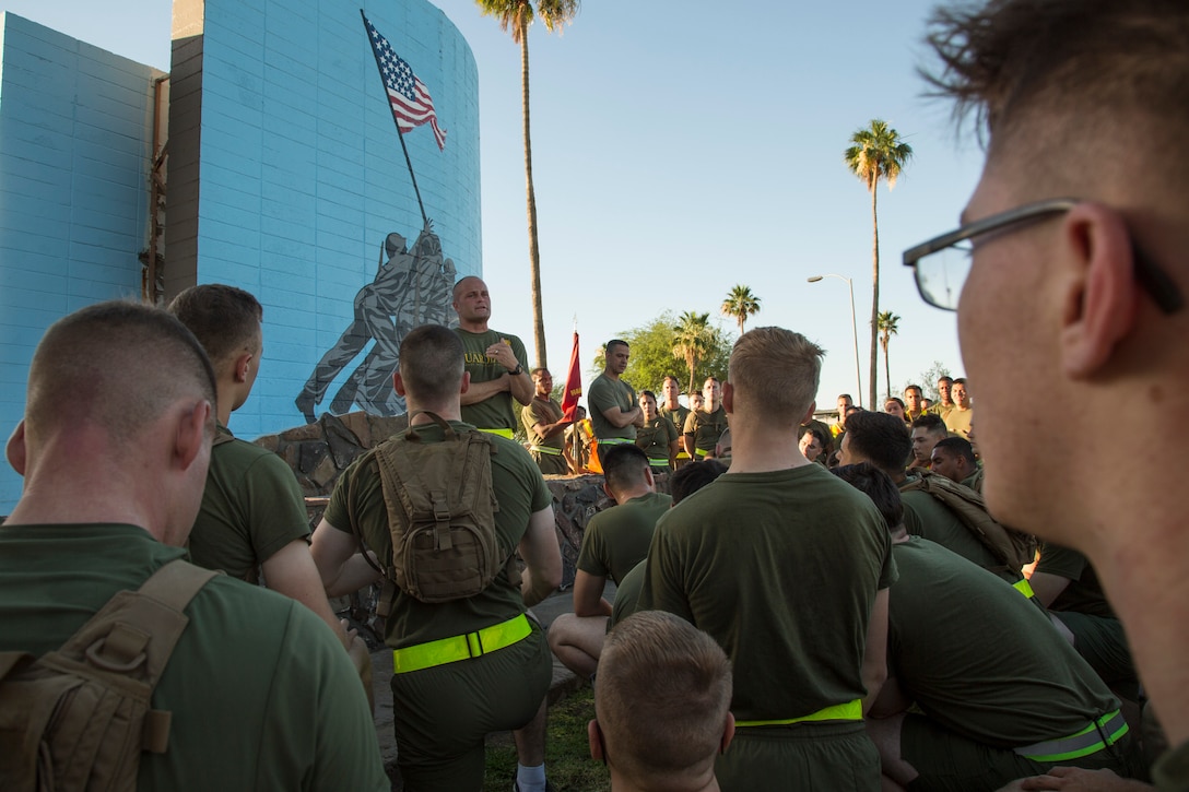 U.S. Marine Corps Lt. Col. James S. Tanis, commanding officer of Headquarters and Headquarters Squadron (H&HS), Marine Corps Air Station (MCAS) Yuma, Ariz., addresses Marines after conducting a motivational run on MCAS Yuma, Ariz., May 25, 2018. H&HS conducted the motivational run to kick off the Memorial Day 96 hour liberty period, and to say farewell to Lt. Col. Tanis who served as the commanding officer of H&HS  for the past two years. (U.S. Marine Corps photo by Sgt. Allison Lotz)