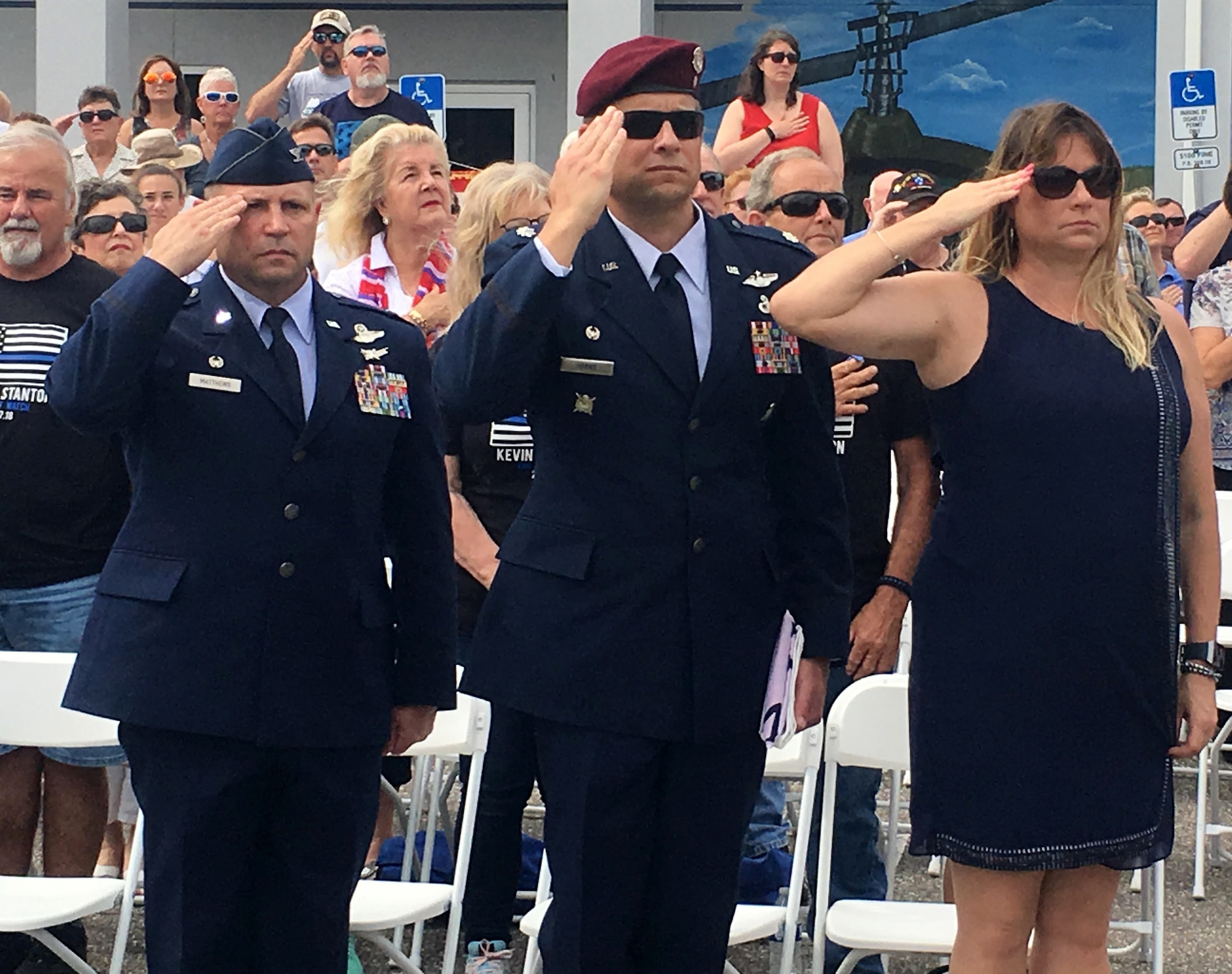 A year-and-a-half into commanding the 920th Rescue Wing and Col. Kurt A. Matthews, shown left, is getting ready to attend his fourth burial. The tragedy of the past year brought Memorial Day 2018 into perspective for 2,000 Reserve Citizen Airmen that serve with the 920th RQW. Matthews honored the lives of four wing members who were lost within the past year, two who were killed in combat March 15, 2018, MSgt. Bill Posch and SSgt. Carl Enis. During the event at the Brevard Veterans Center, Matthews, left; Lt. Col. Tim Hanks, shown center, 308th Rescue Squadron commander, and Hank's wife, Heather Hanks, render a salute to honor the ultimate sacrifice of 308th members Posch and Enis. (U.S. Air Force photo by Mr. Darrell Hankins)