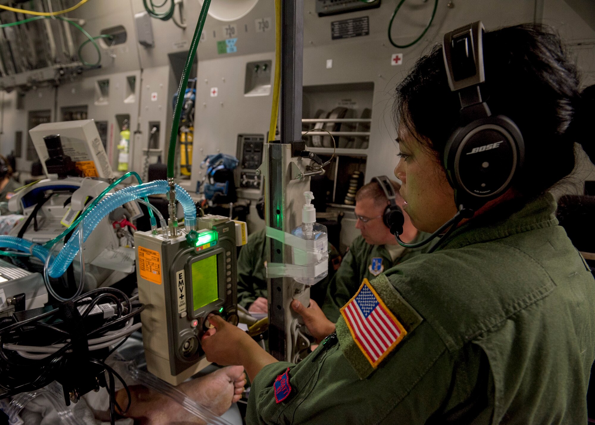 U.S. Air Force Master Sgt. Virginia Holmgren, a 124th Medical Group respiratory therapist with the Idaho Air National Guard, adjusts a patient’s ventilation levels on board a C-17 Globemaster III from Travis Air Force Base, Calif., after leaving Joint Base Pearl Harbor-Hickam, Hawaii, May 18, 2018. Holmgren was part of a critical care air transport team providing medical supervision of a patient back to Travis. (U.S. Air Force photo by Lan Kim)