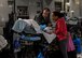 Capt. Thomas Hagan, 123rd Medical Group critical care air transport team nurse looks on as a patient is consoled by their family inside a C-17 Globemaster III from Travis Air Force Base, Calif., flying over the Pacific Ocean, May 18, 2018. The C-17 was configured by an aeromedical evacuation aircrew to provide aerial transport of patients throughout the Pacific region. (U.S. Air Force photo by Lan Kim)