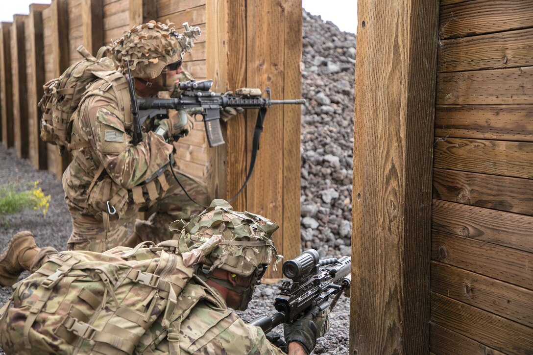 Soldiers provide cover fire during a combined arms live-fire exercise.