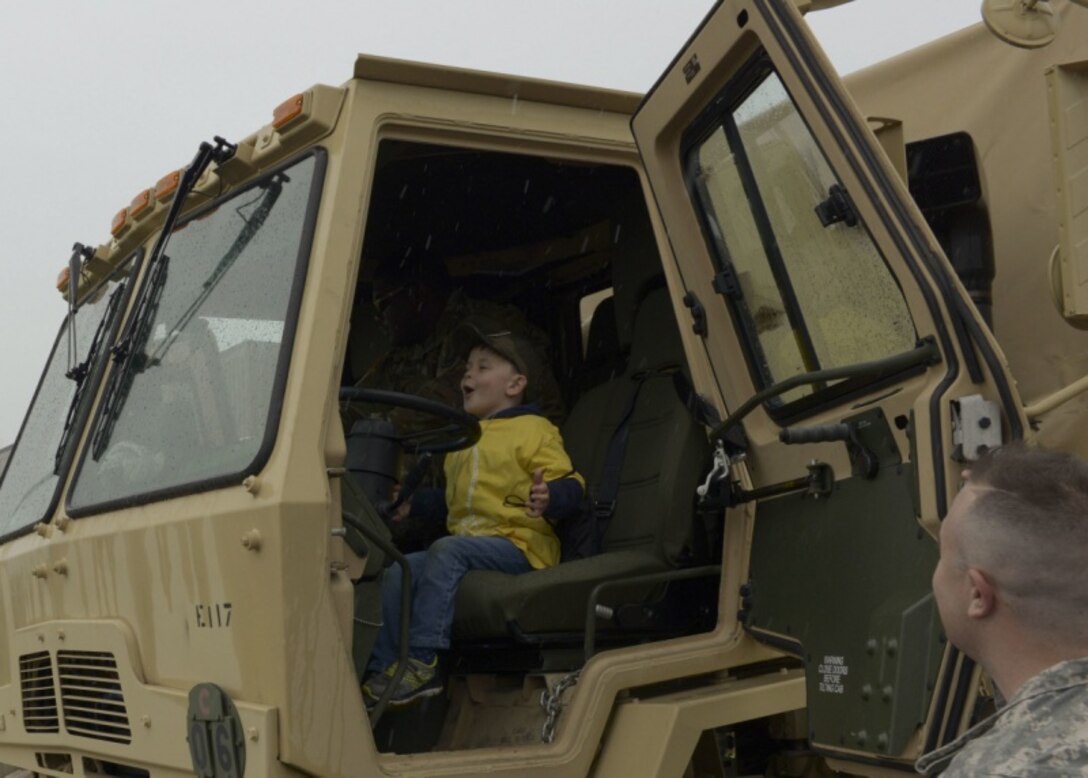 The child of a Connecticut National Guardsmen sits in the driver's seat of an Army vehicle May 19, 2018.