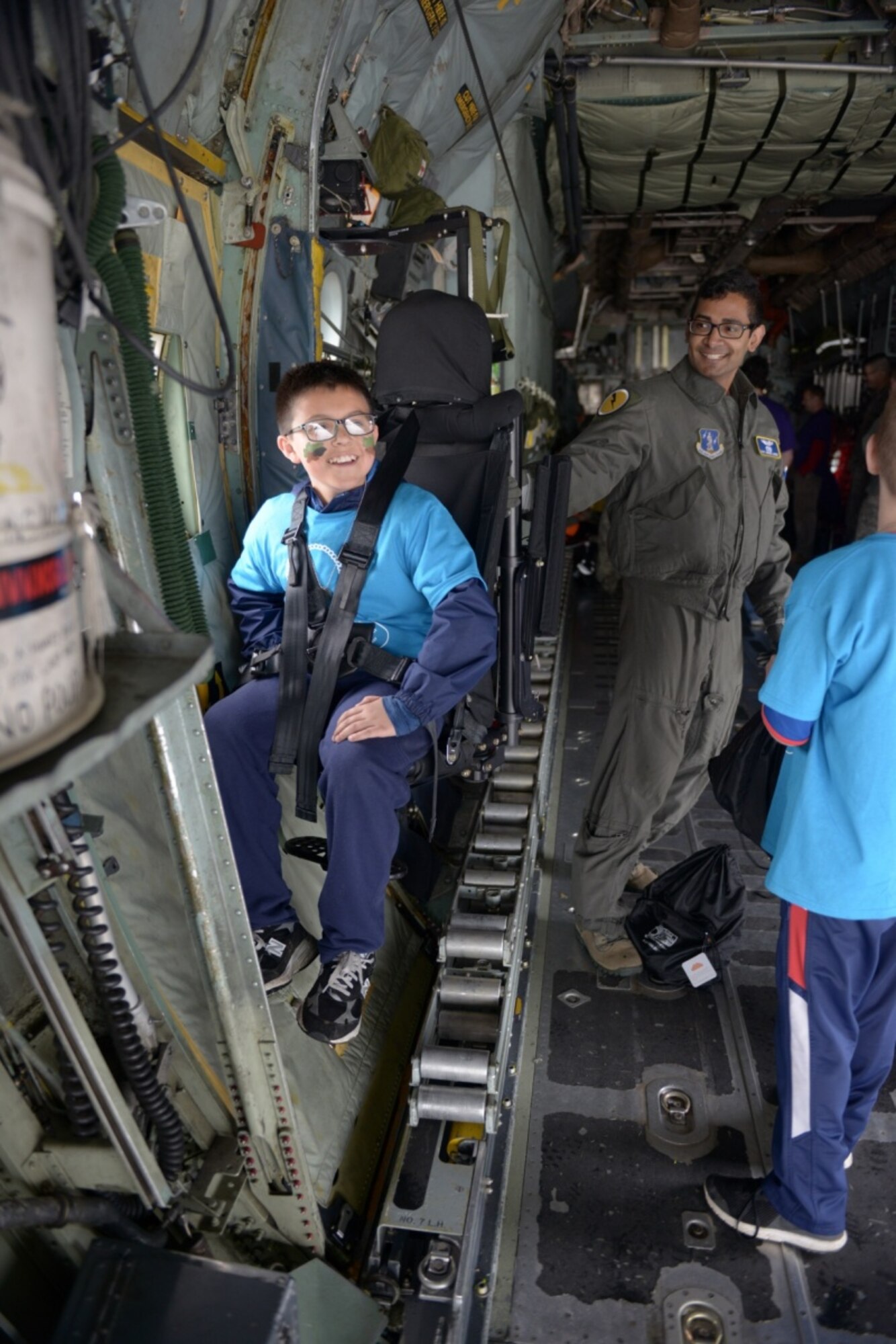 The child of a Connecticut National Guardsman sits in a C-130 Hercules May 19, 2018.