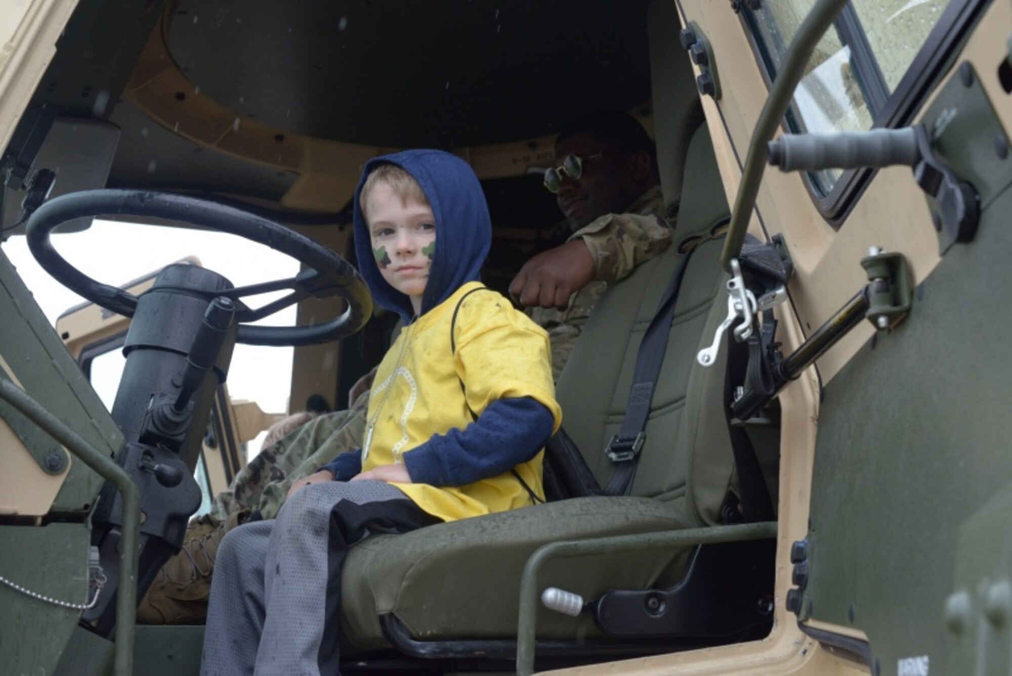 A child of a Connecticut National Guardsman sits in an Army vehicle May 19, 2018.