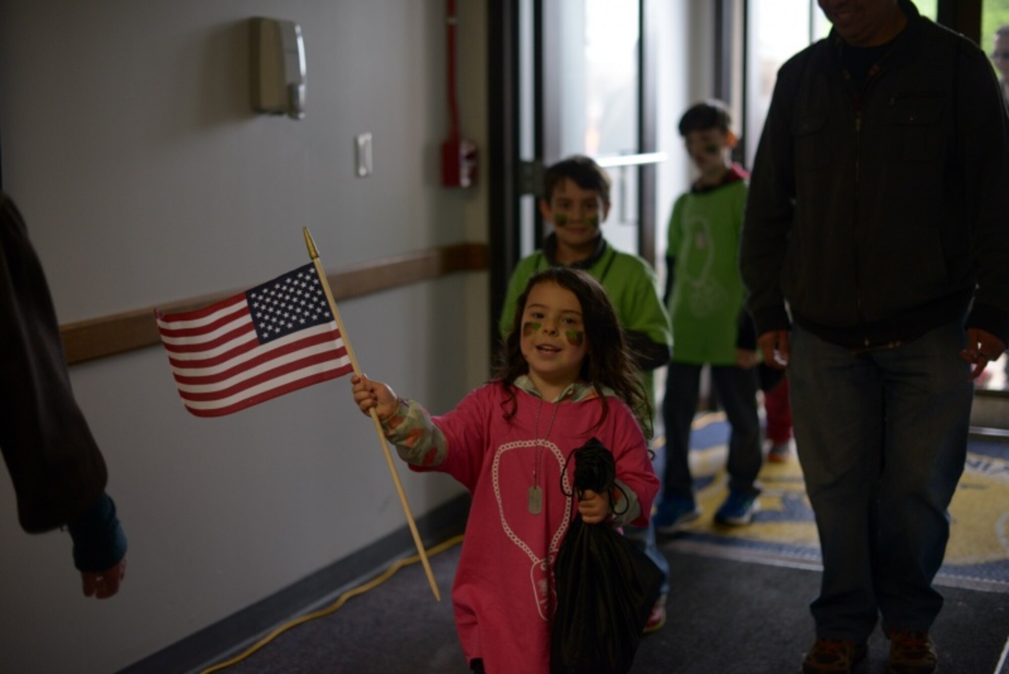 A child of a Connecticut National Guardsman waves an American Flag after returning from a simulated deployment May 19, 2018