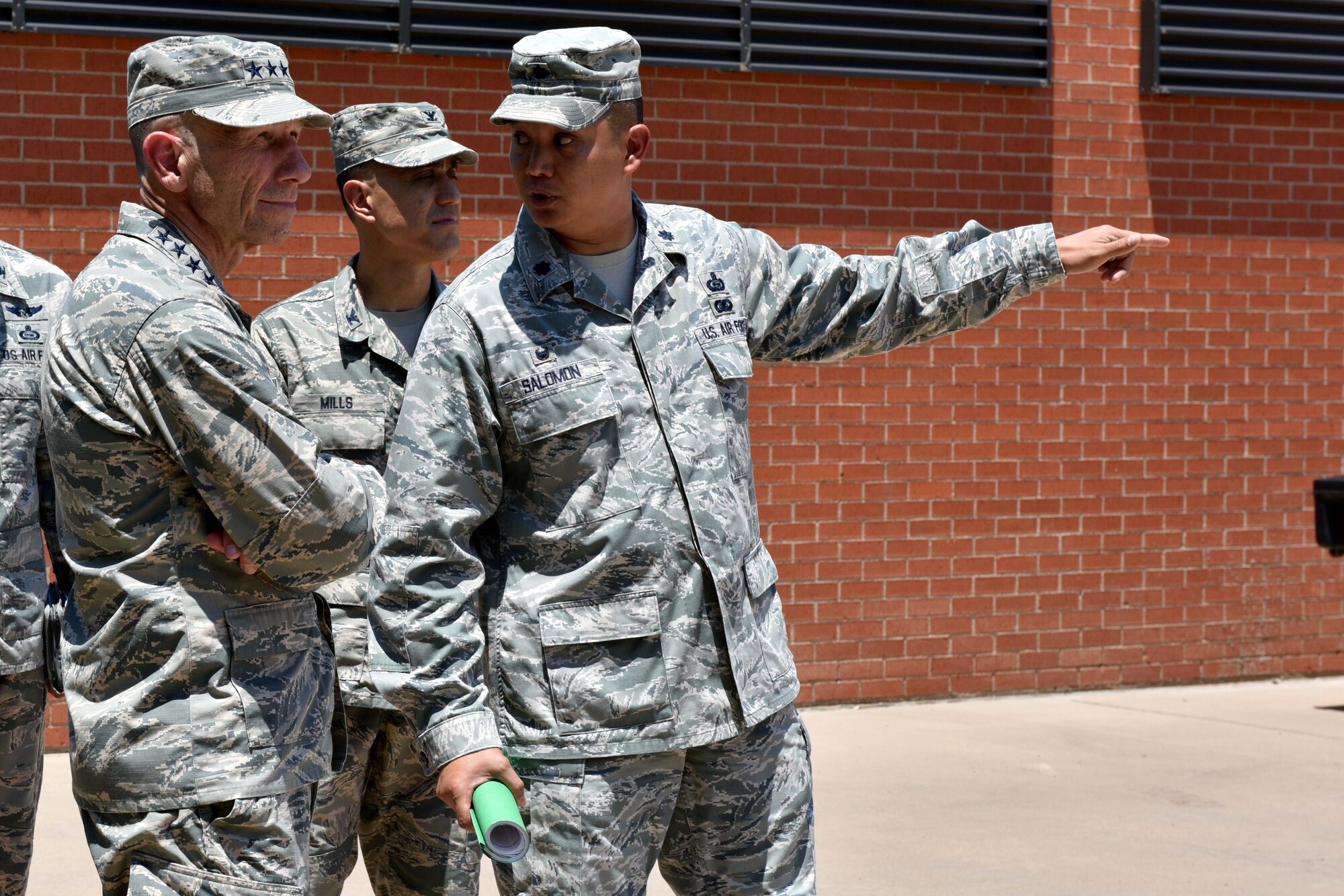U.S. Air Force Lt. Col. Abraham Salomon, 17th Training Support Squadron commander, speaks with Gen. Mike Holmes, Commander of Air Combat Command, on Goodfellow Air Force Base, Texas, May 30, 2018. Holmes visited Goodfellow to understand the intelligence, surveillance, reconnaissance training and to meet with San Angelo civic leaders. (U.S. Air Force photo by Senior Airman Randall Moose/Released)