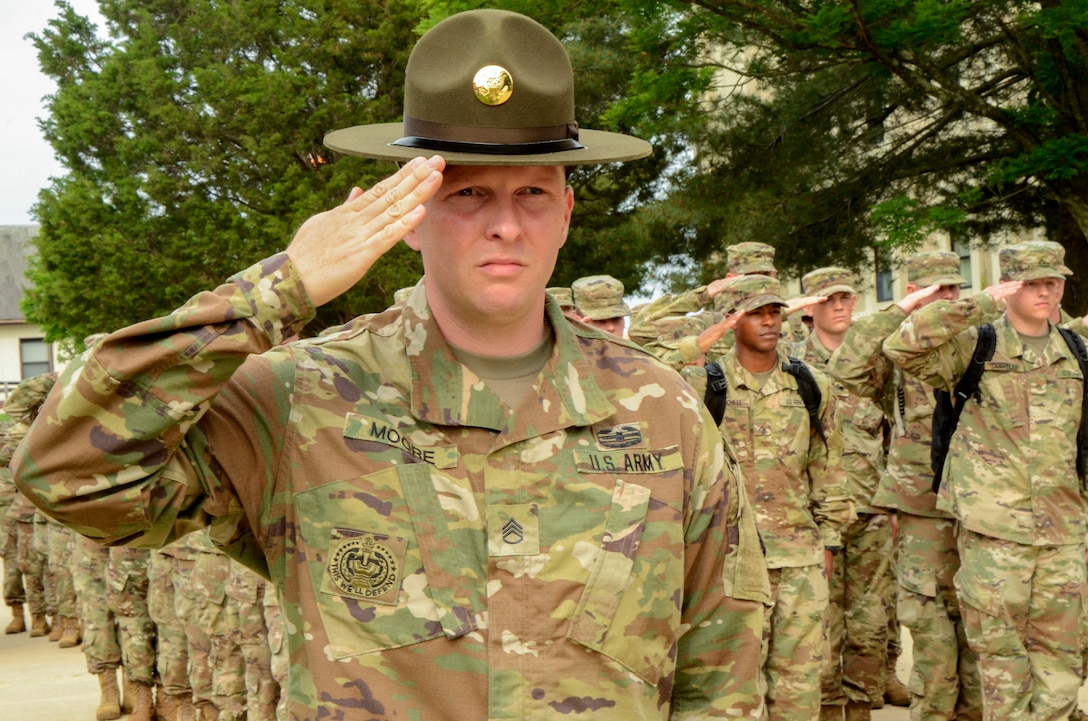 Army Staff Sgt. Joseph D. Moore salutes while in formation.