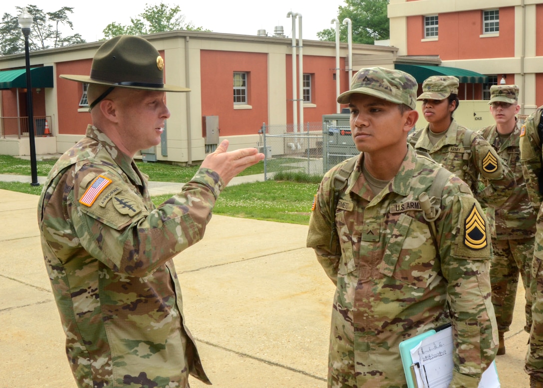 Army Staff Sgt. Joseph D. Moore gives instruction to Army Pvt. Marc Marmeto