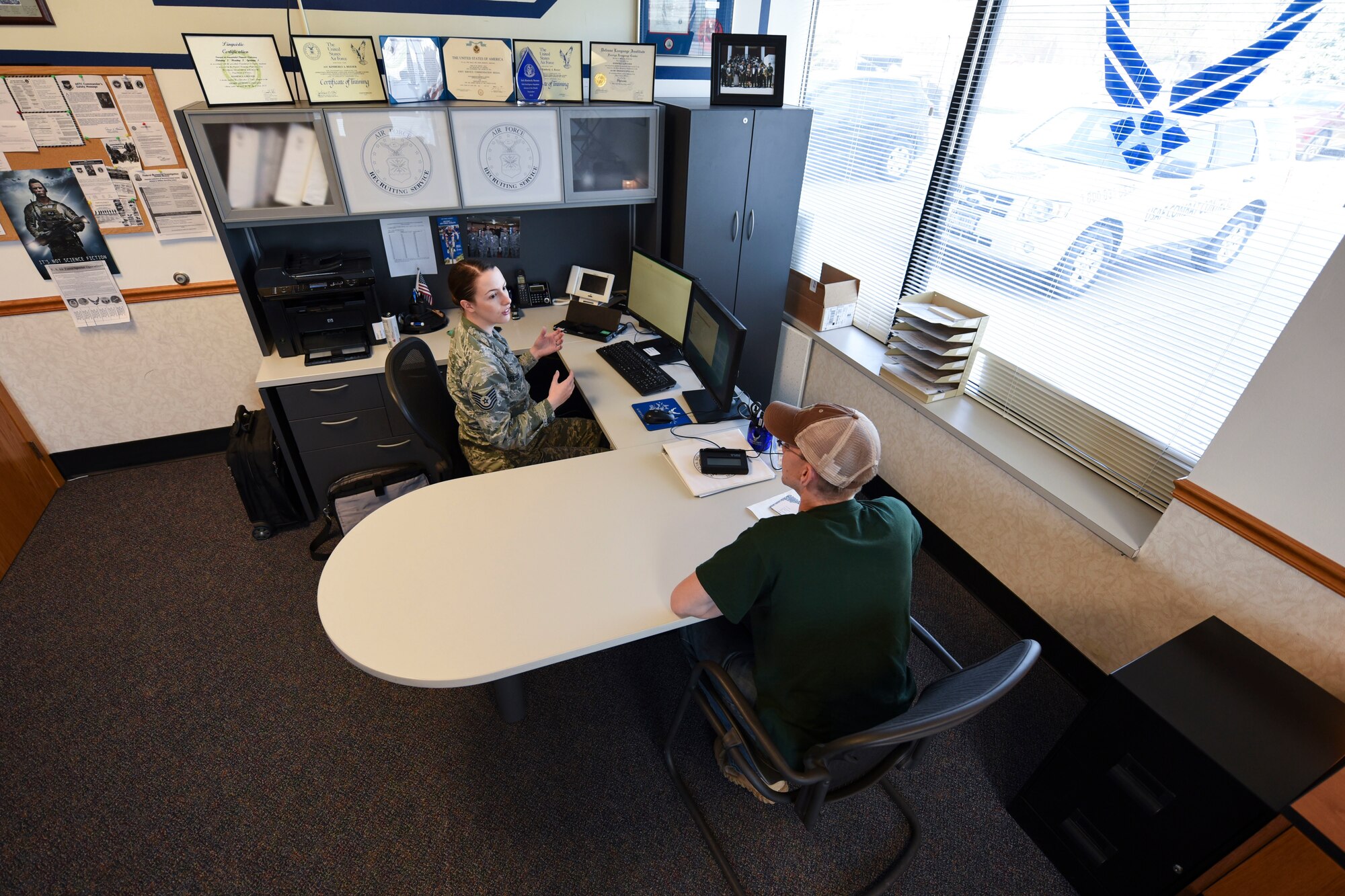 Air Force Tech. Sgt. Kimberly Reeser, recruiter located in Grand Forks, North Dakota, assists a recruit with the transition into the military here. Reeser said she feels a sense of accomplishment helping people become eligible to join the military. (U.S. Air Force photo by Airman 1st Class Melody K. Wolff)