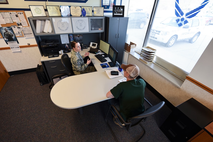 Air Force Tech. Sgt. Kimberly Reeser, recruiter located in Grand Forks, North Dakota, assists a recruit with the transition into the military here. Reeser said she feels a sense of accomplishment helping people become eligible to join the military. (U.S. Air Force photo by Airman 1st Class Melody K. Wolff)