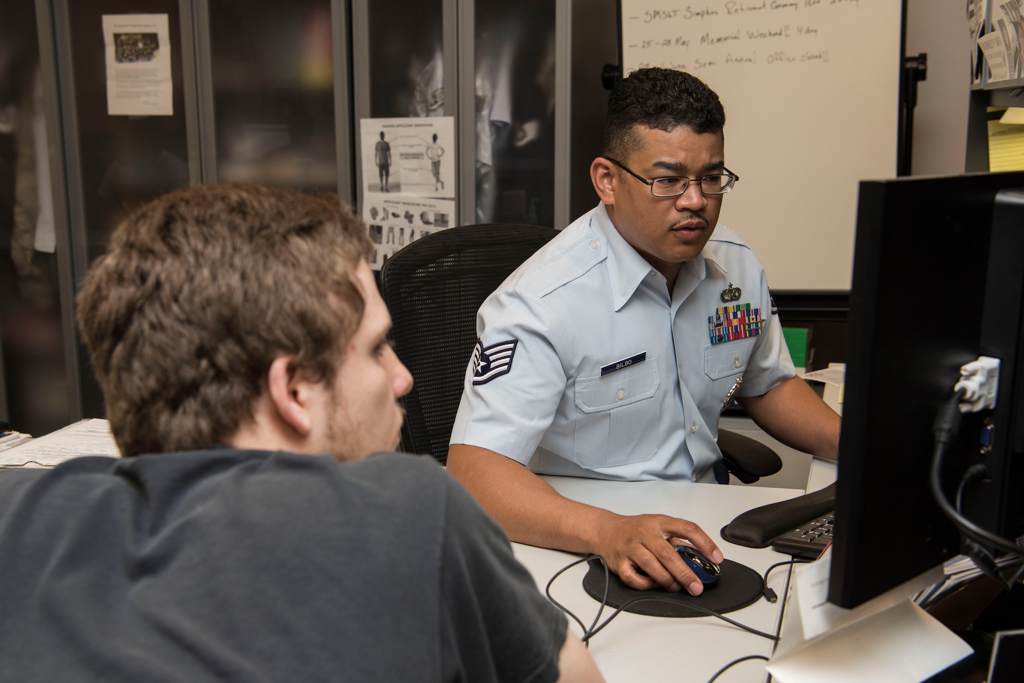 Staff Sgt. Sherard Bilbo, 345th Recruiting Squadron recruiter, speaks with a recruit May 14, 2018, at the Air Force Recruiting Office, Faiview Heights, Illinois. A recruiter's mission is to inspire, engage and recruit new Airmen. (U.S. Air Force photo by Senior Airman Melissa Estevez)