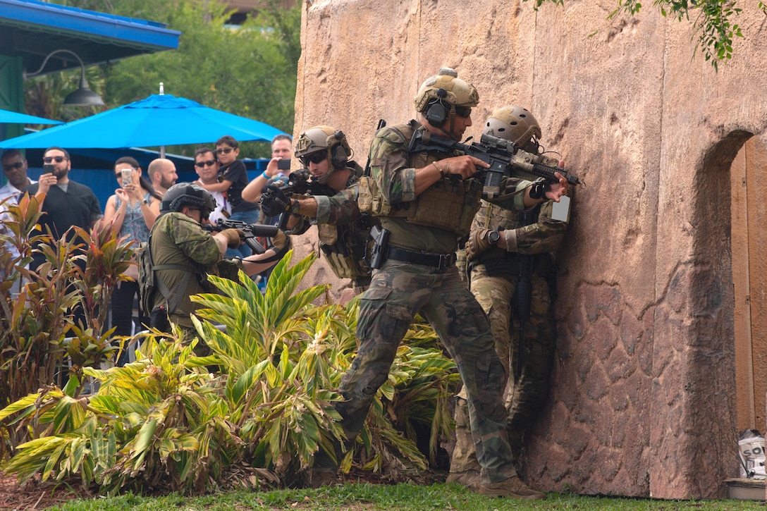 U.S. and multinational special operations forces prepare to enter a building.