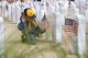 A local cub scout places a flag at the grave of a past servicemembers May 26 at Bakesfield National Cemetery. (U.S. Air Force photo by Christopher Okula