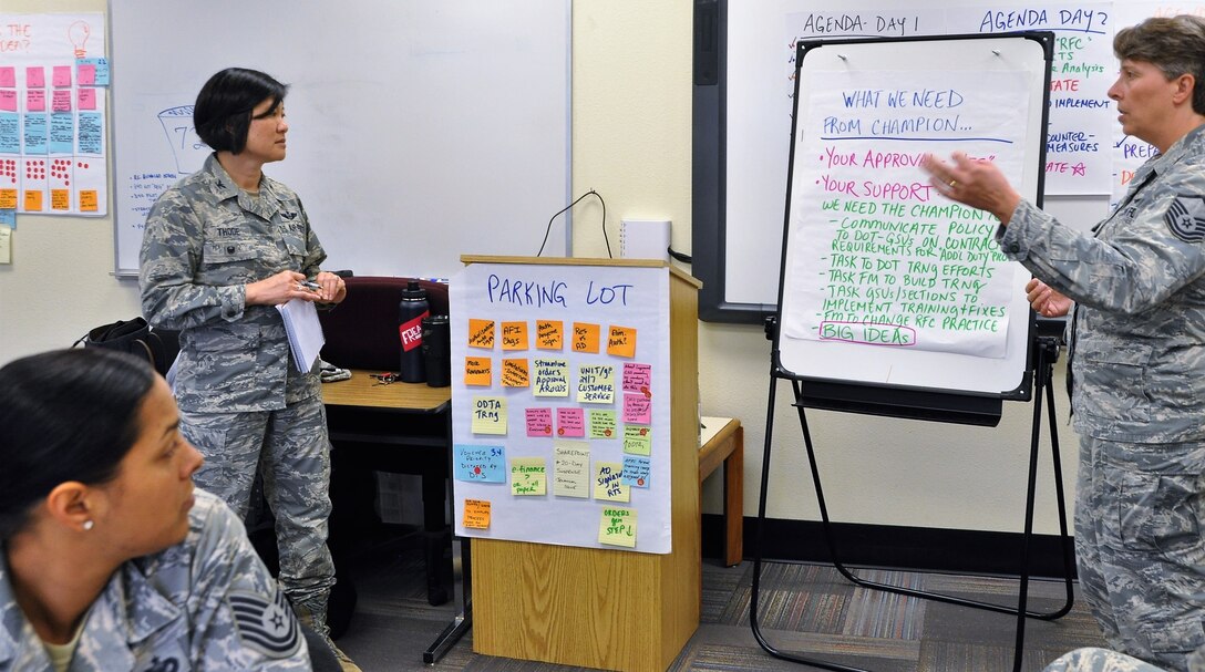 Master Sgt. Amy Whitman-Rector, team lead and 340th FTG financial analysis section chief, explains what the improvement team needs from the process champion to Group Deputy Commander Col. Janette Thode, who stood in for improvement process champion Col. Allen Duckworth.  Also pictured is Tech. Sgt. Alexis Leyva, improvement team member from (433rd TRS). (U.S. Air Force photo by Janis El Shabazz)