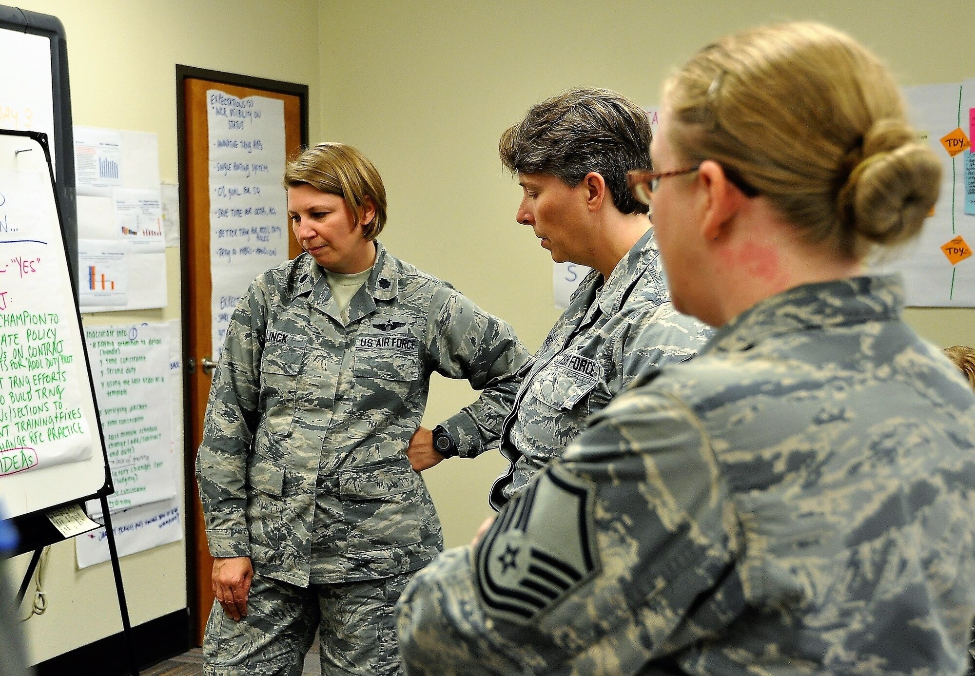 340th FTG CPI manager, Lt. Col. Sara Linck, Master Sgt. Amy Whitman-Rector (C) and Master Sgt. Latisha Melendez survey outbrief statements during the recent Financial Management travel voucher process CPI event. (U.S. Air Force photo by Janis El Shabazz)