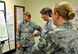 340th FTG CPI manager, Lt. Col. Sara Linck, Master Sgt. Amy Whitman-Rector (C) and Master Sgt. Latisha Melendez survey outbrief statements during the recent Financial Management travel voucher process CPI event. (U.S. Air Force photo by Janis El Shabazz)