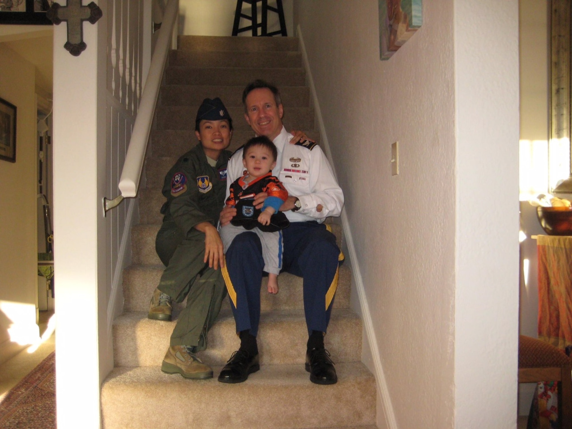 Lt. Col. An Duong, the 28th Medical Group chief of aerospace medicine, sits with her family in their home in Ohio in 2014. Duong was born in Vietnam, but moved to the United States and became a medical professional before commissioning into the Air Force. (Courtesy photo)
