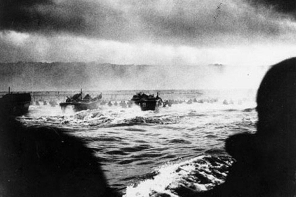 Landing craft approach a beach.