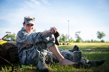 Master Sgt. Kay Williams, 919th Special Operations Security Forces Squadron, treats blisters on her feet moments after she and fellow team members completed a seven-mile ruck march May 5, 2018 near Duke Field, Fla.