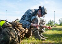Master Sgt. Kay Williams, 919th Special Operations Security Forces Squadron, laces her boots after she and her team paused to care for their feet following a seven-mile ruck march May 5, 2018 near Duke Field, Fla.