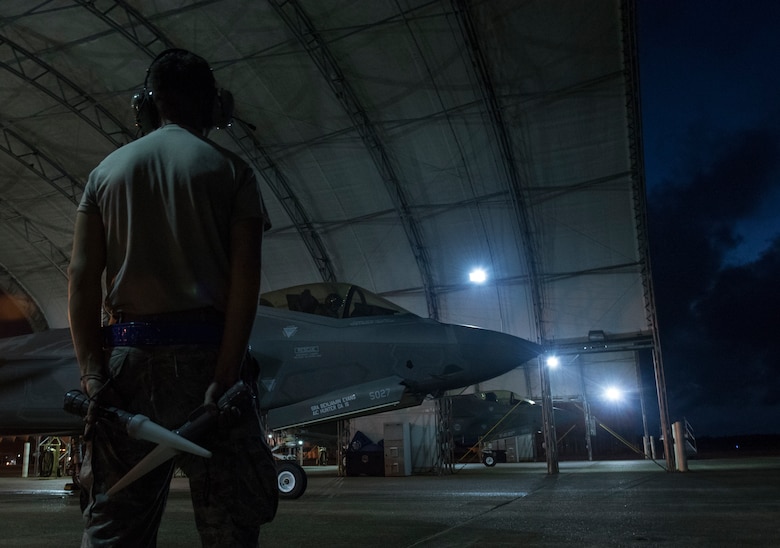 U.S. Air Force Senior Airman Daniel Portilla-Romero, 33rd Aircraft Maintenance Squadron crew chief, stands near an F-35A Lightning II as they await permission to taxi May 30, 2018, at Eglin Air Force Base, Fla. The 33 FW conducted F-35A night flying operations May 29-31, 2018, satisfying a training requirement for student pilots who will routinely fly day and night operations upon entering the combat Air Force. During this iteration of the pilot training syllabus, the night flying portion was stretched later into evening hours than in the past, allowing for more qualifications to be checked off across fewer days. (U.S. Air Force photo by Staff Sgt. Peter Thompson)