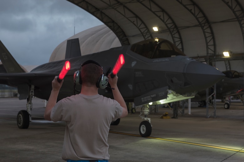 U.S. Air Force Senior Airman Jared Ray, 33rd Aircraft Maintenance Squadron crew chief, marshals an F-35A Lightning II May 30, 2018, at Eglin Air Force Base, Fla. The 33 FW conducted F-35A night flying operations May 29-31, 2018, satisfying a training requirement for student pilots who will routinely fly day and night operations upon entering the combat Air Force. During this iteration of the pilot training syllabus, the night flying portion was stretched later into evening hours than in the past, allowing for more qualifications to be checked off across fewer days. (U.S. Air Force photo by Staff Sgt. Peter Thompson)