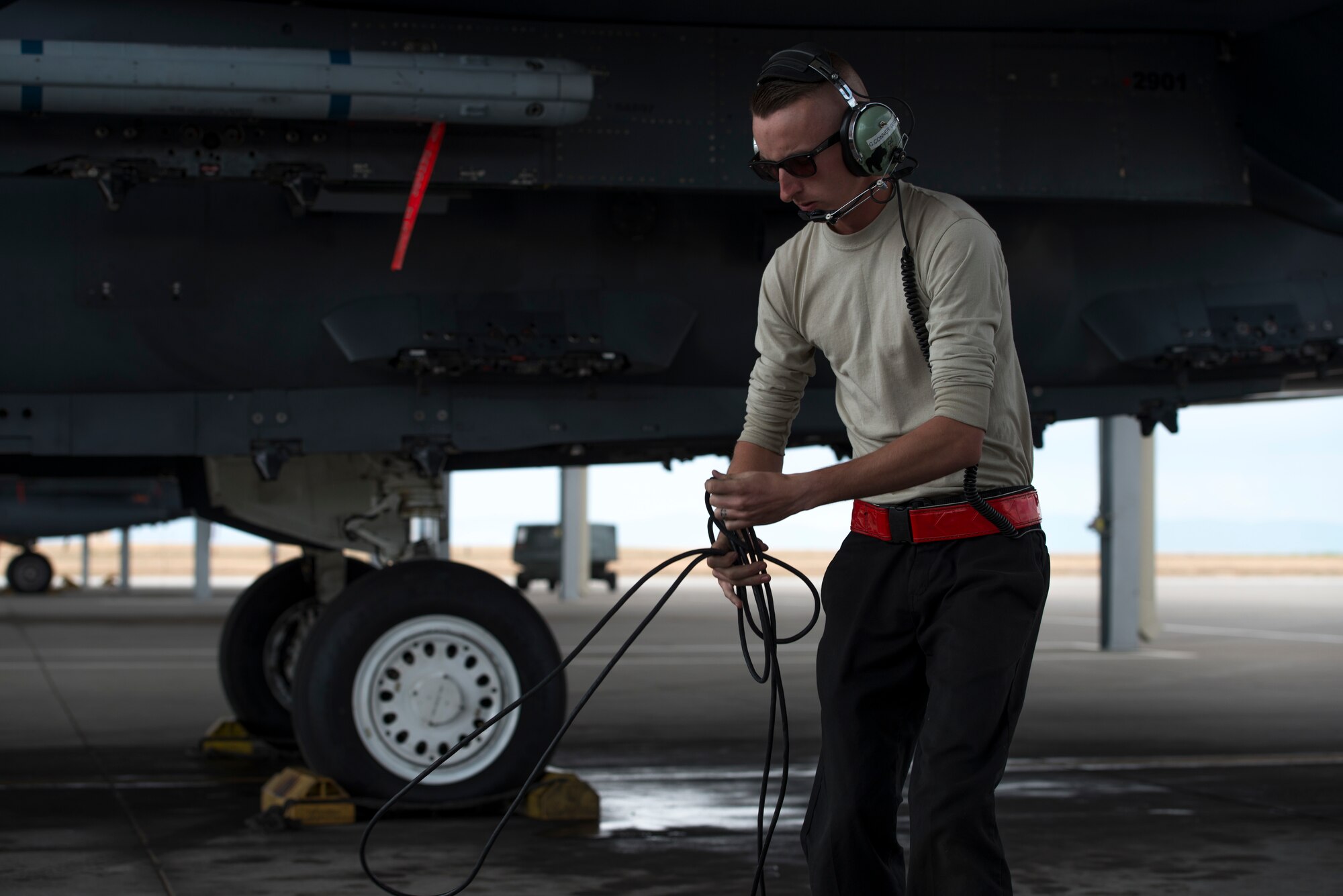 Airman 1st class Corey Connor, 389th Fighter Squadron crew chief, wraps up a cord during an exercise, May 22, 2018 at Mountain home Air Force Base, Idaho. Gunfighter Flag 18-2 encompassed both the Belgian Air Component and Idaho Civil Air Patrol. (U.S. Air Force photo by Airman 1st Class JaNae Capuno)