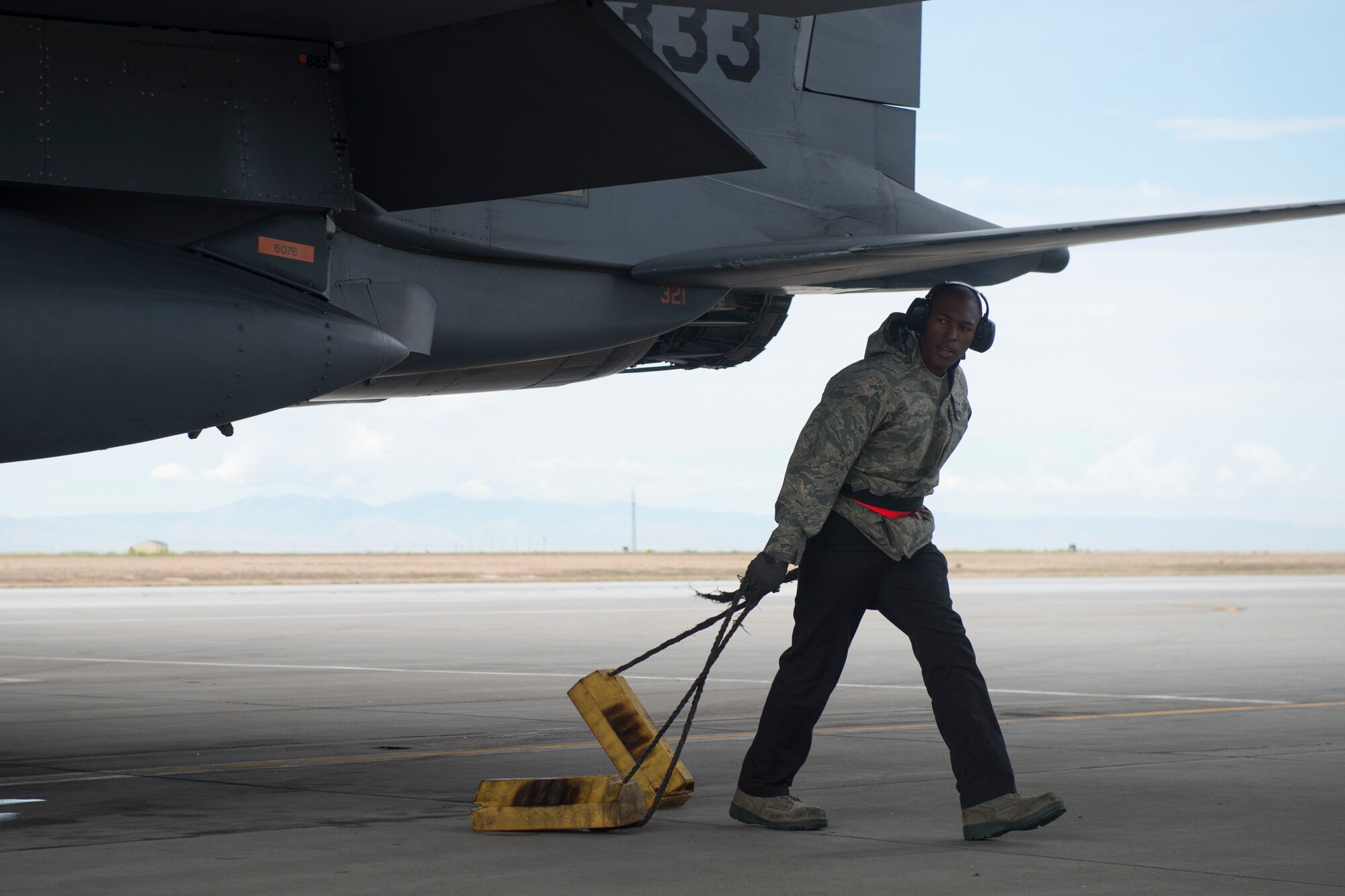 Airman 1st Class Dexter Holiday, 366th Aircraft Maintenance Squadron weapons load crew member, pulls the chocks from an F-15E Strike Eagle during an exercise, May 23, 2018 at Mountain home Air Force Base, Idaho. Gunfighter Flag 18-2 encompassed both the Belgian Air Component and Idaho Civil Air Patrol. (U.S. Air Force photo by Airman 1st Class JaNae Capuno)