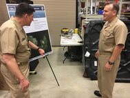 IMAGE: CMDR Steve Perchalski (left) discusses Naval Surface Warfare Center (NSWC) Dahlgren Division's directed energy facilties during NSWC Commander Rear Adm Thomas Anderson's visit, May 31. The admiral spent the day getting familiar with the division's portfolio of capabilities.