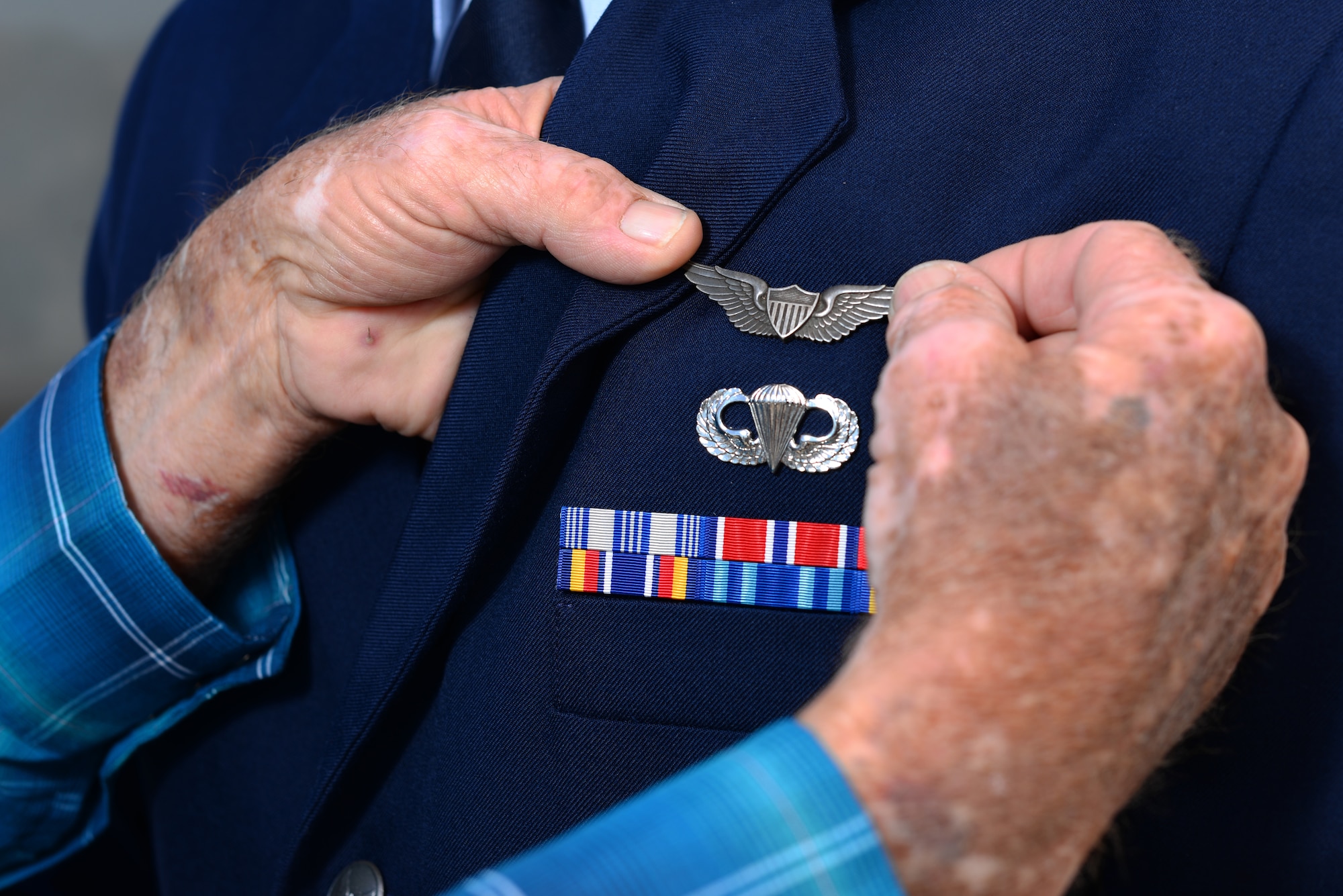 Lt. Col. (ret.) Thomas Byrd, former pilot, pins a pair of heritage wings to the chest of 2nd Lt. Colin Asbury at Laughlin Air Force Base, Texas, May 18, 2018. Byrd passed the wings he received from his uncle who was killed in action in WWII, to Asbury, who is now moving on to fly the F-15E Strike Eagle, a dream he has had since childhood. (U.S. Air Force photo by Senior Airman Benjamin N. Valmoja)