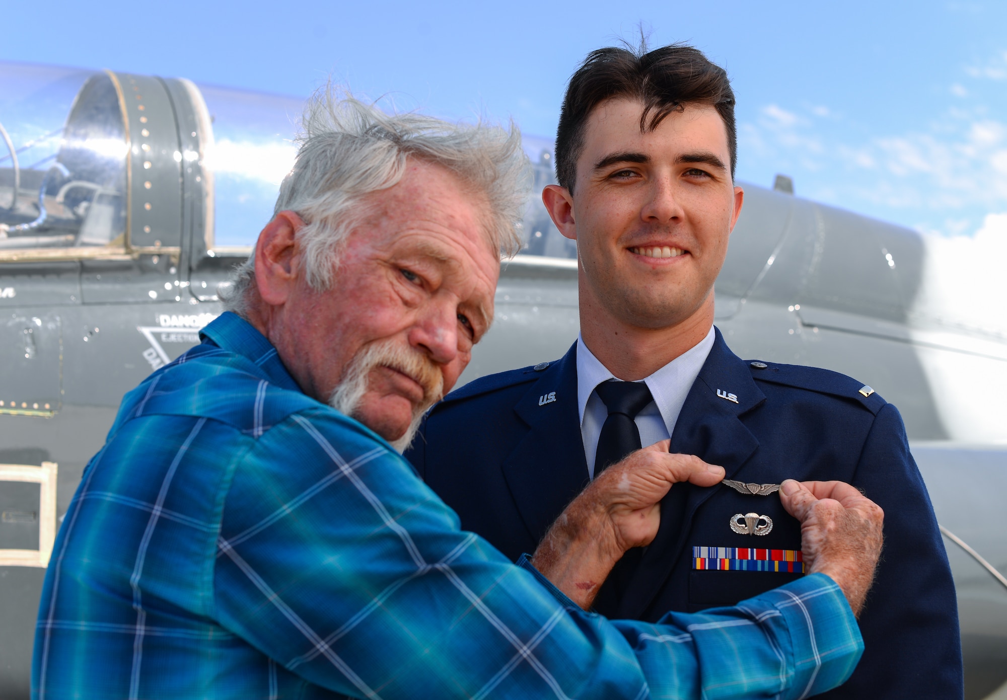 Lt. Col. (ret.) Thomas Byrd, former pilot, pins a pair of heritage wings to the chest of 2nd Lt. Colin Asbury at Laughlin Air Force Base, Texas, May 18, 2018. Byrd, credited with more than 3,000 hours flying the F-4 Phantom and more than 1,000 hours in the F-16 Fighting Falcon, passes his uncle’s wings to Asbury, who had dreamed about flying since he was a child. (U.S. Air Force photo by Senior Airman Benjamin N. Valmoja)