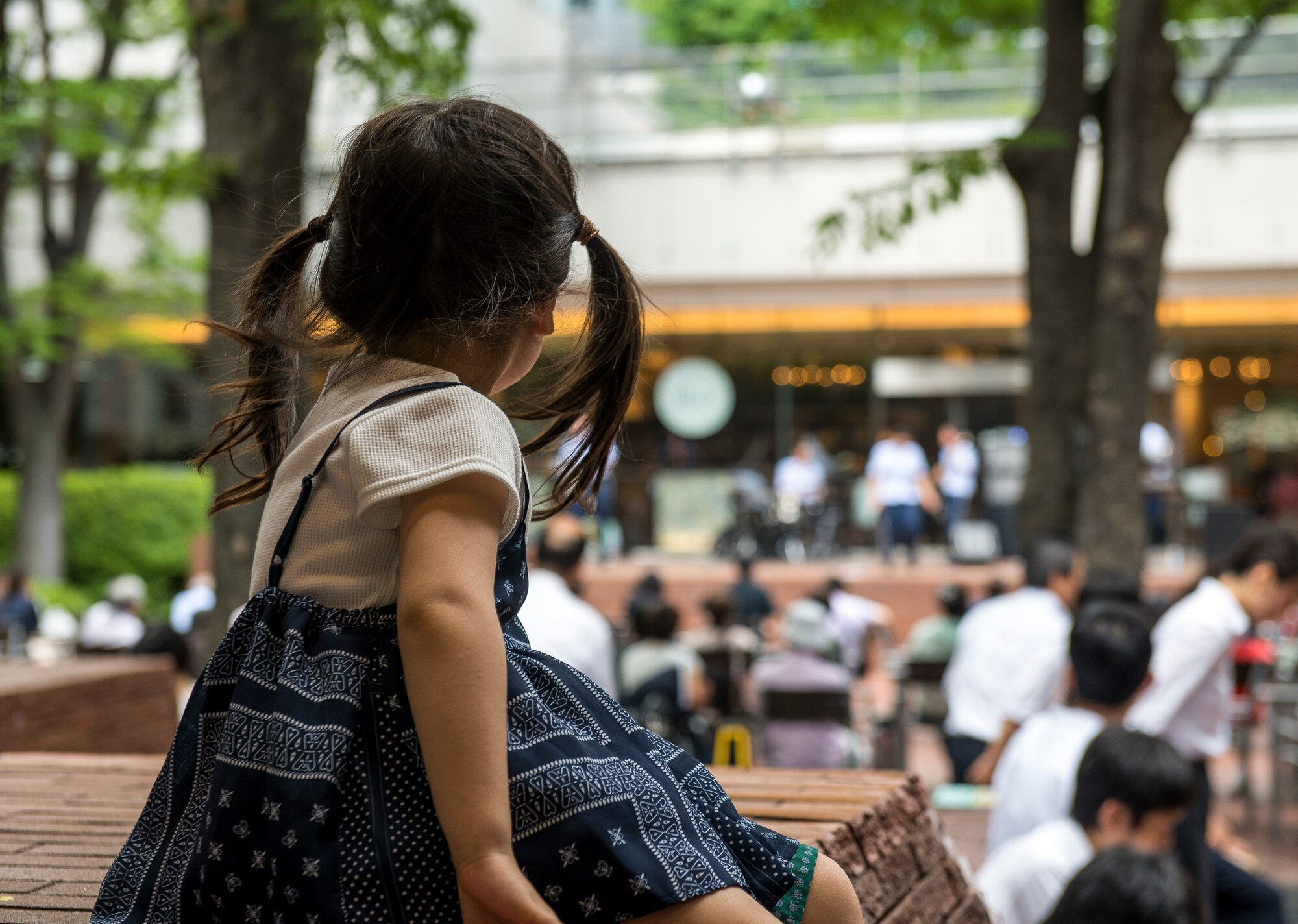 A child watches the U.S. Air Force Band of the Pacific-Asia ensemble Final Approach, performing