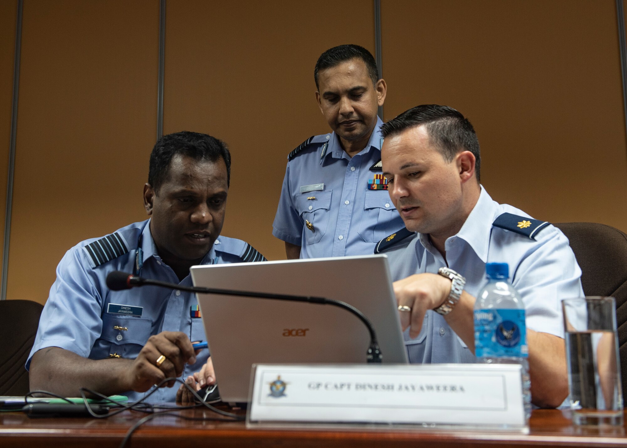 Sri Lanka Air Force Group Capt. Dinesh Jayaweera, Palaly Air Base commander (left), Group Capt. Asela Jayasekara, training staff officer, and U.S. Air Force Maj. Mark Lesar, Pacific Air Forces international affairs division country director for South Asia, work together during the SLAF, USAF Airman to Airman Talks mid-May, 2018, in the SLAF Headquarters, Sri Lanka.