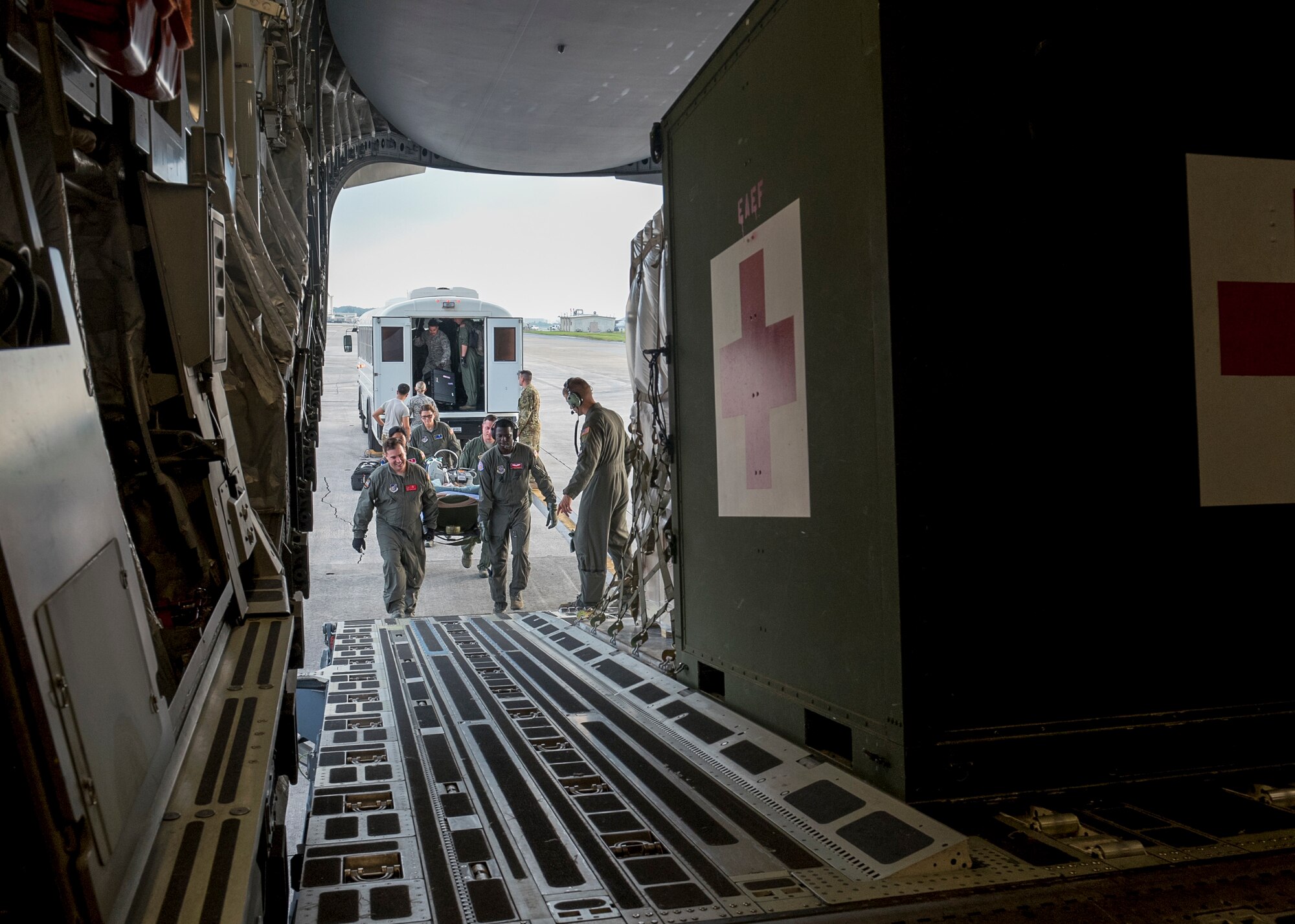 An aeromedical evacuation and critical care air transport team consisting of Airmen from the 375th AE Squadron, 18th AE Squadron, 673rd Medical Group, 36th Medical Group and 124th Medical Group, load a priority care patient onto a C-17 Globemaster III at Kadena Air Base, Japan, May 17, 2018. The C-17 from Travis AFB, Calif., was configured by an AE aircrew to provide aerial transport of patients throughout the Pacific region. (U.S. Air Force photo by Lan Kim)