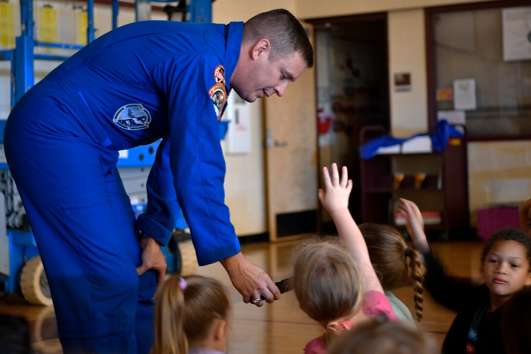 Children ask Col. Jack “2 Fish” Fischer, NASA astronaut, questions about his experiences in space during a general assembly, May 22, 2018, at Aurora Quest K-8 School, Aurora, Colorado. The special guest was a surprise to the nearly 600 students in attendance.(U.S. Air Force photo by Senior Airman Madison J. Ratley)