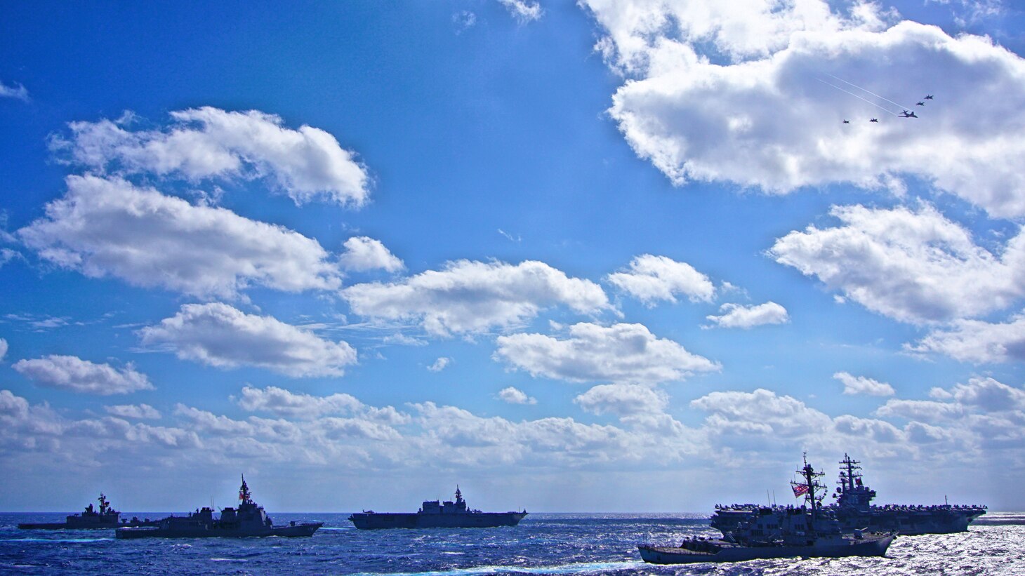 File Photo: SEA OF JAPAN, U.S. Air Force and Japan Air Self-Defense Force aircraft fly over a formation of U.S. Navy and Japan Maritime Self-Defense Force ships including, USS Shiloh (CG 67), USS Barry (DDG 52), JS Oumi (AOE 426), JS Ashigara (DDG 178), JS Akizuki (DD115), JS Kurama (DDH 144), JS Yamagiri (DD 152), USS Chancellorsville (DDG 62), USS Chicago (SSN 721) and JS Souryu (SS 501) signifying the conclusion of Keen Sword 17 (KS17).