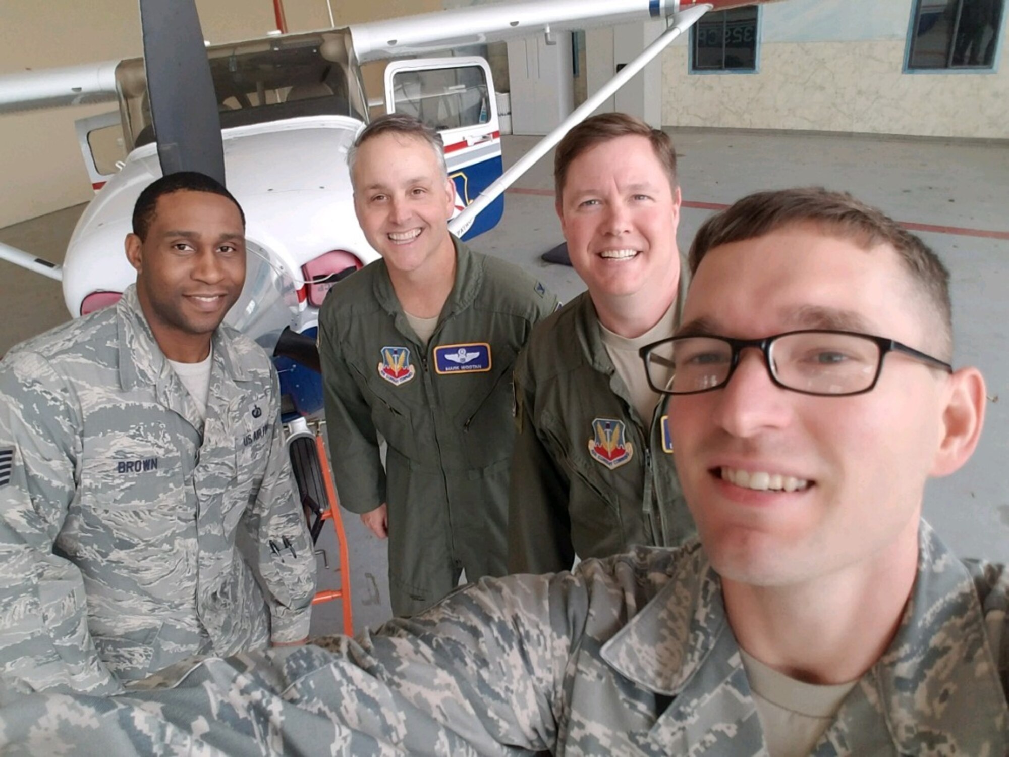 Tech. Sgt. Ben Brown (far left), and Staff Sgt. Aaron Pearson (far right), both subject matter experts from the Business and Enterprise Systems Directorate, receive servers from Tyndall Air Force Base, that were delivered by members of the Civil Air Patrol (courtesy photo).
