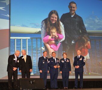 TSgt Mitchell Thompson, center, receives the Airlift/Tanker Association's Gen. Dutch Huyser Award at the 2018 A/TA and Air Mobility Command Symposium held at the Gaylord Texan Resort in Grapevine, Texas, Oct. 26, 2018. Representatives from the A/TA as well as Gen. David Goldfein, Air Force chief of staff, Gen. Maryanne Miller, AMC commander, and Chief Master Sgt. Larry Williams, AMC command chief, presented Thompson with his award.