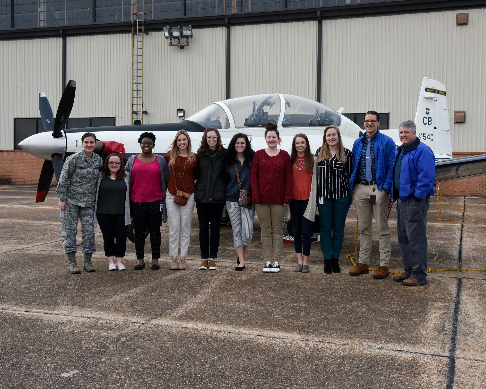 Mississippi State University veterinary students stand in front of a T-6 Texan II Oct. 23, 2018, on the flight line at Columbus Air Force Base, Mississippi. The students gained an opportunity to visit the 14th Security Forces Squadron Military Working Dog Kennel and static displays of aircraft. (U.S. Air Force photo by Sharon Ybarra)