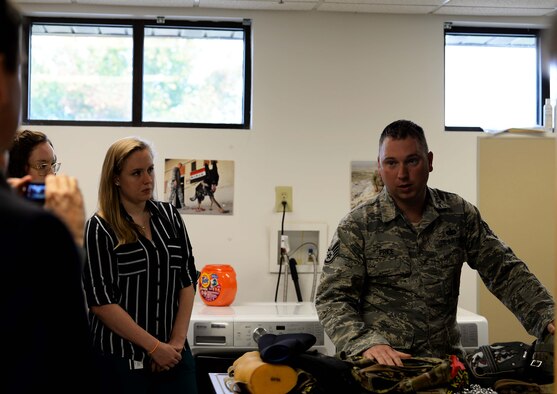 Staff Sgt. Matthew Price, 14th Security Forces Squadron military working dog trainer, shows various gear used by MWD handlers to Mississippi State University veterinary students Oct. 23, 2018, at the MWD kennel on Columbus Air Force Base, Mississippi. The equipment used by the handlers aid both in real world scenarios as well as training environments. (U.S. Air Force photo by Airman Hannah Bean)