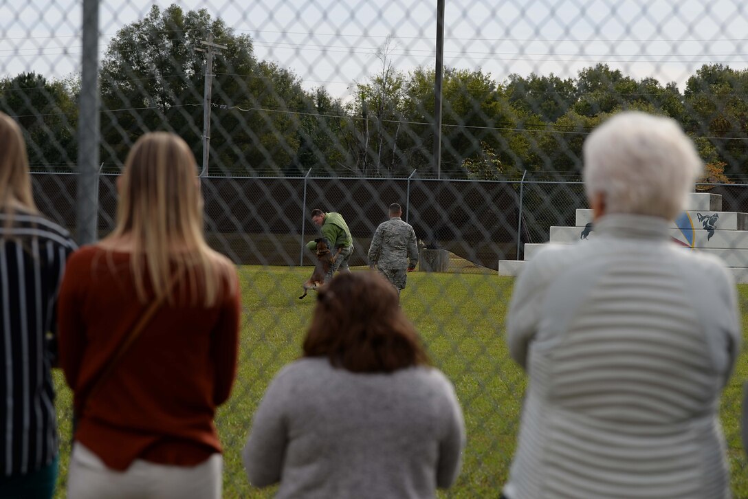 Mississippi State University veterinary students watch as Airman 1st Class Ryan Younger, 14th Security Forces Squadron installation entry controller, gets bit by military working dog Dito as Senior Airman Marini, 14th SFS MWD handler, gives orders Oct. 23, 2018, at the MWD kennel on Columbus Air Force Base, Mississippi. Members of the 14th SFS MWD Kennel showcased real world scenarios in a training environment to give a better understanding of the lifestyle of an MWD. (U.S. Air Force photo by Airman Hannah Bean)