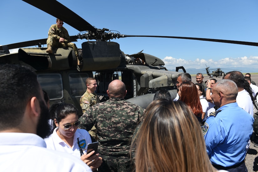 National Defense College students talk about helicopter capabilities with subject matter experts during a visit to Soto Cano Air Base, Honduras, Oct. 25, 2018.