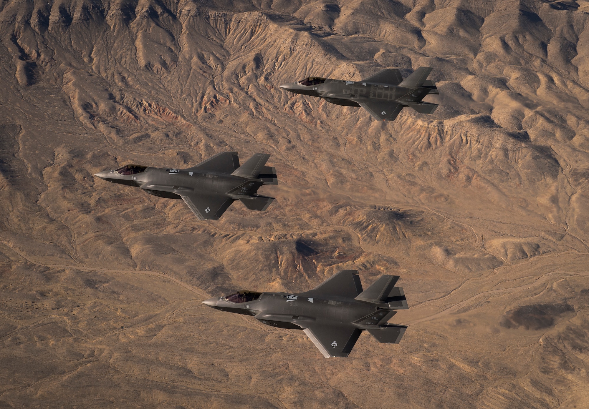 Three U.S. Air Force F-35A Lightning IIs, assigned to the 4th Fighter Squadron from Hill Air Force Base, Utah, conduct flight training operations over the Utah Test and Training Range. The F-35A is a single-seat, single engine, fifth generation, multirole fighter that’s able to perform ground attack, reconnaissance and air defense missions with stealth capability. (U.S. Air Force photo by Staff Sgt. Andrew Lee)
