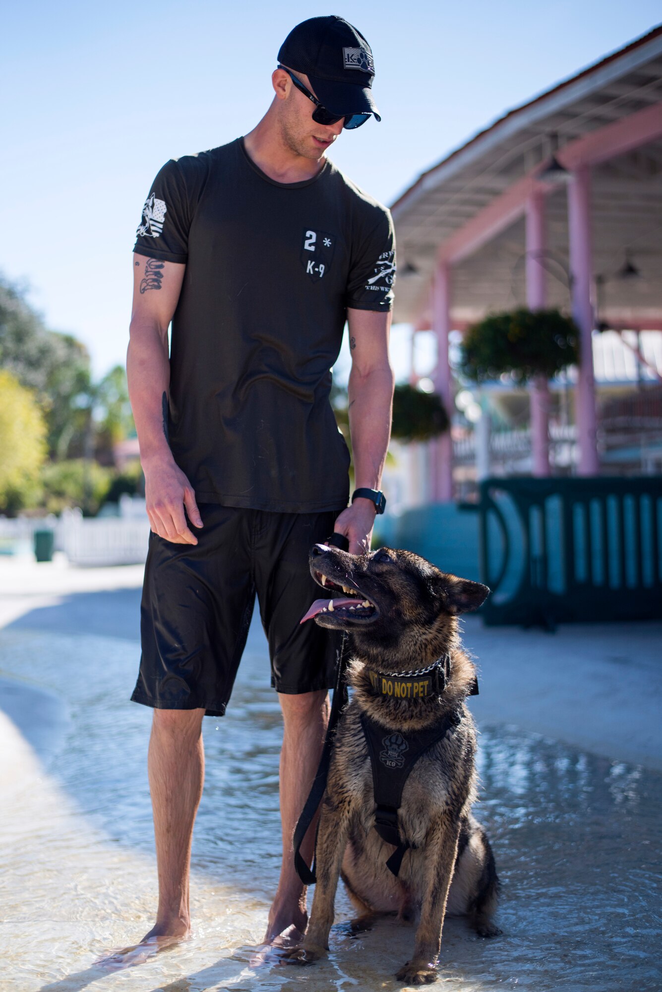 U.S. Air Force Staff Sgt. Austin Cook, a military dog handler assigned to the 6th Security Forces Squadron, pauses for a photo with his military working dog, Zeno, at Adventure Island, Tampa, Fla. Oct. 29, 2018.