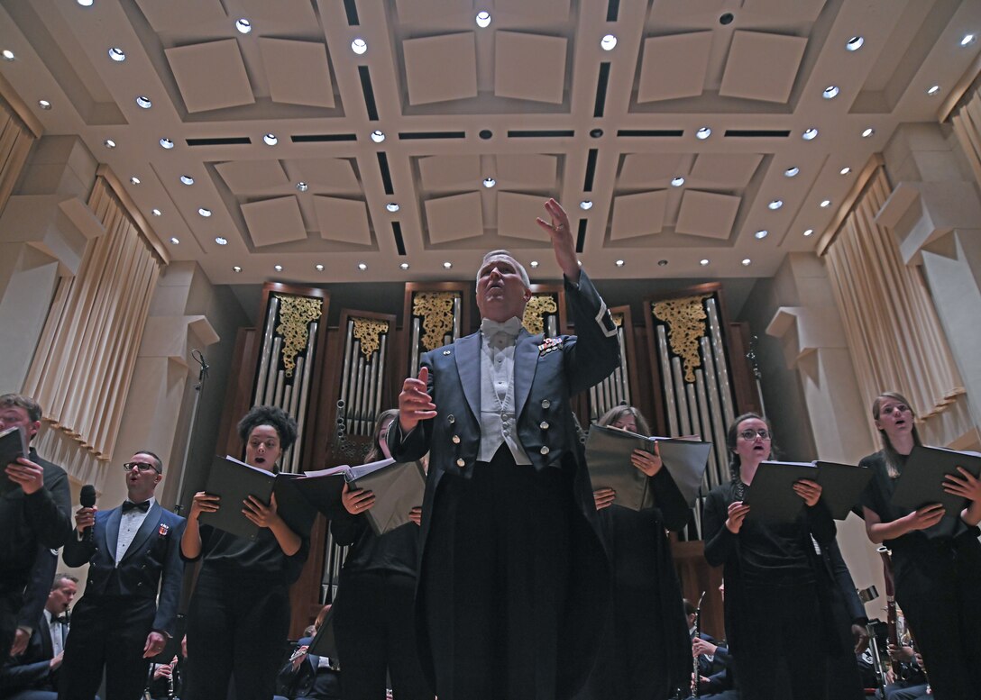 Col. Larry H. Lang, U.S. Air Force Band commander and conductor, invites the crowd to sing along with the band and Baylor University choir students at Baylor University in Waco, Texas, Oct. 24, 2018. On Lang’s final trip before retirement, the band toured 12 locations in New Mexico and Texas, including Lang’s hometown of El Paso, Texas. (U.S. Air Force photo by Senior Airman Abby L. Richardson)