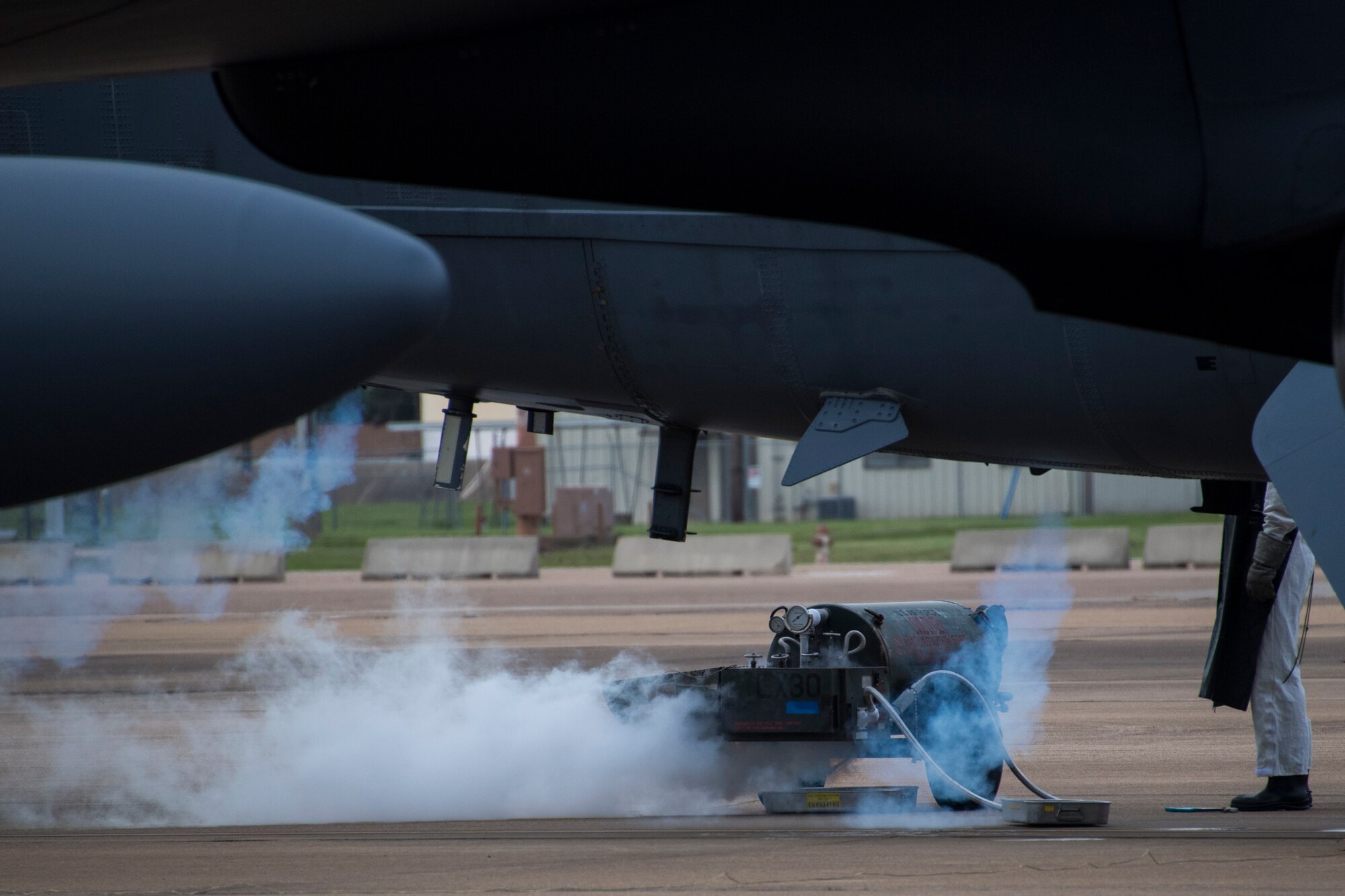 Liquid nitrogen creates a cloud as an Airman prepares to maintain oxygen bottles aboard a B-52 Stratofortress at Barksdale Air Force Base, Louisiana, Oct. 10, 2018.  Although routine maintenance, the bottles are a critical piece of equipment aboard the jet, as it can reach altitudes of up to 50,000 feet. (U.S. Air Force photo by Master Sgt. Ted Daigle)