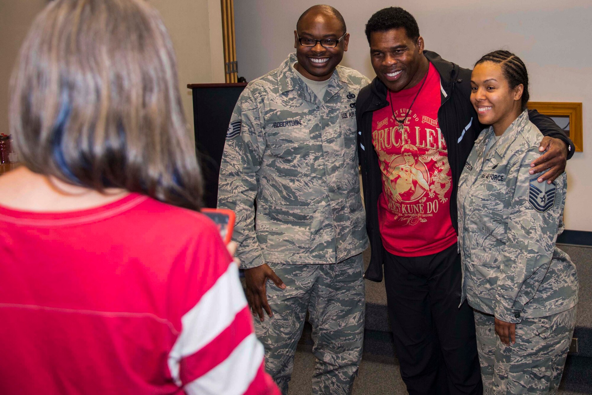 Former Heisman Trophy winner and NFL running back, Herschel Walker, poses with Airmen during a visit to Barksdale Air Force Base, Louisiana, Oct. 15, 2018.  He came to the 307th Bomb Wing headquarters building to discuss resiliency and how he coped with his own battles with dissociative identity disorder.  He also took time to answer questions about his career and sign memorabilia. (U.S. Air Force photo by Master Sgt. Ted Daigle)