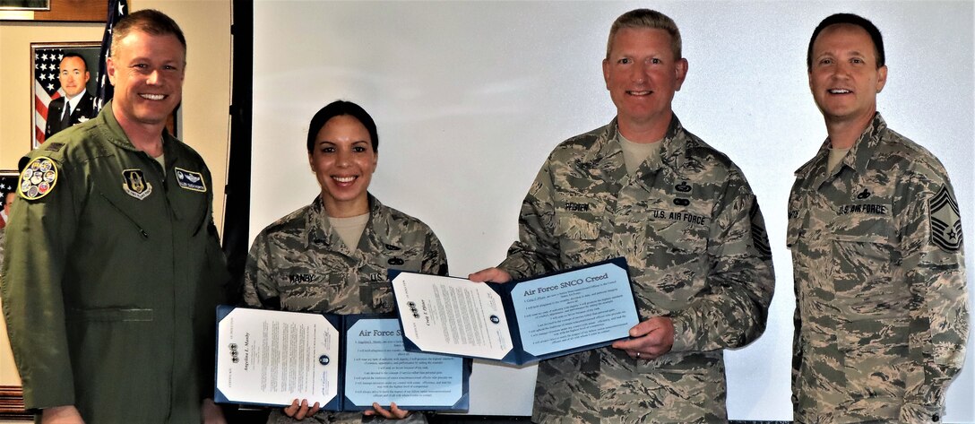 Col. Allen Duckworth, commander of the 340th Flying Training Group, JBSA-Randolph, Texas, poses with new SNCO inductees, Master Sgt. Angelina Manby, Senior Master Sgt. Craig Pfister and 340th FTG group superintendent, Chief Master Sgt. Scott A. Goetze following ceremonies here Nov. 1. (U.S. Air Force photo by Janis El Shabazz)